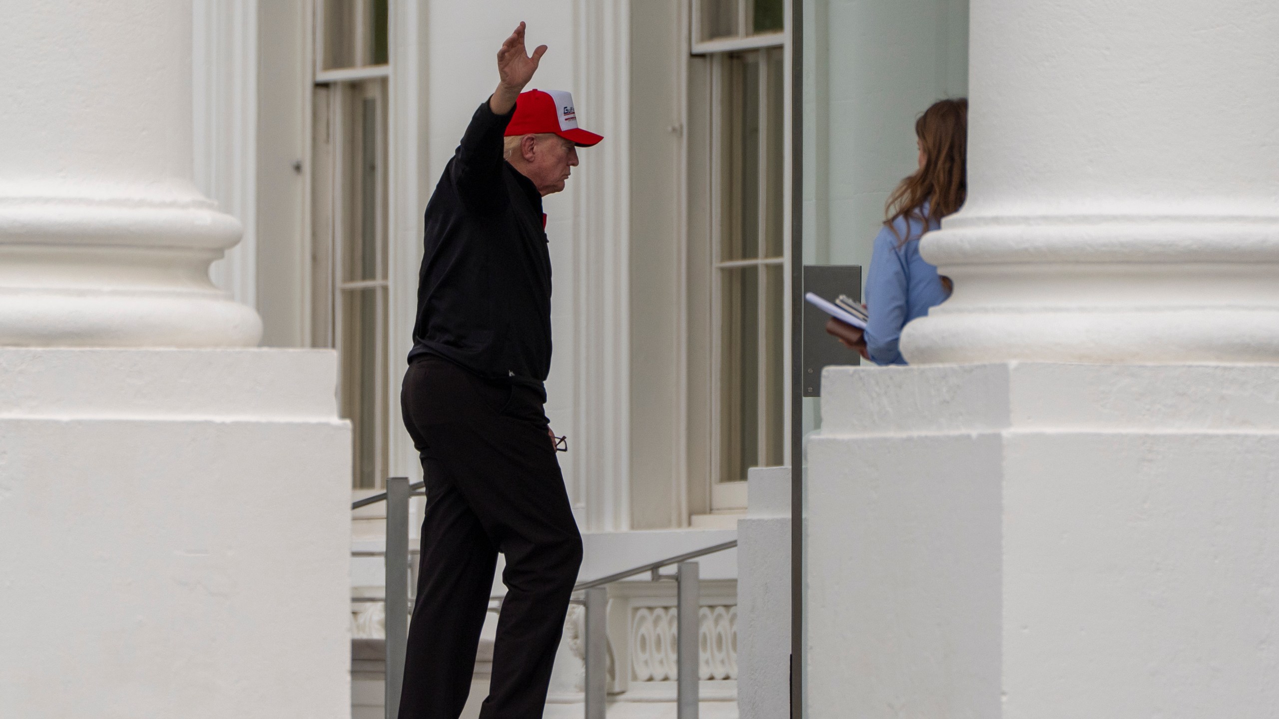 President Donald Trump waves as he returns to the White House, Sunday, April 20, 2025, in Washington. (AP Photo/Alex Brandon)