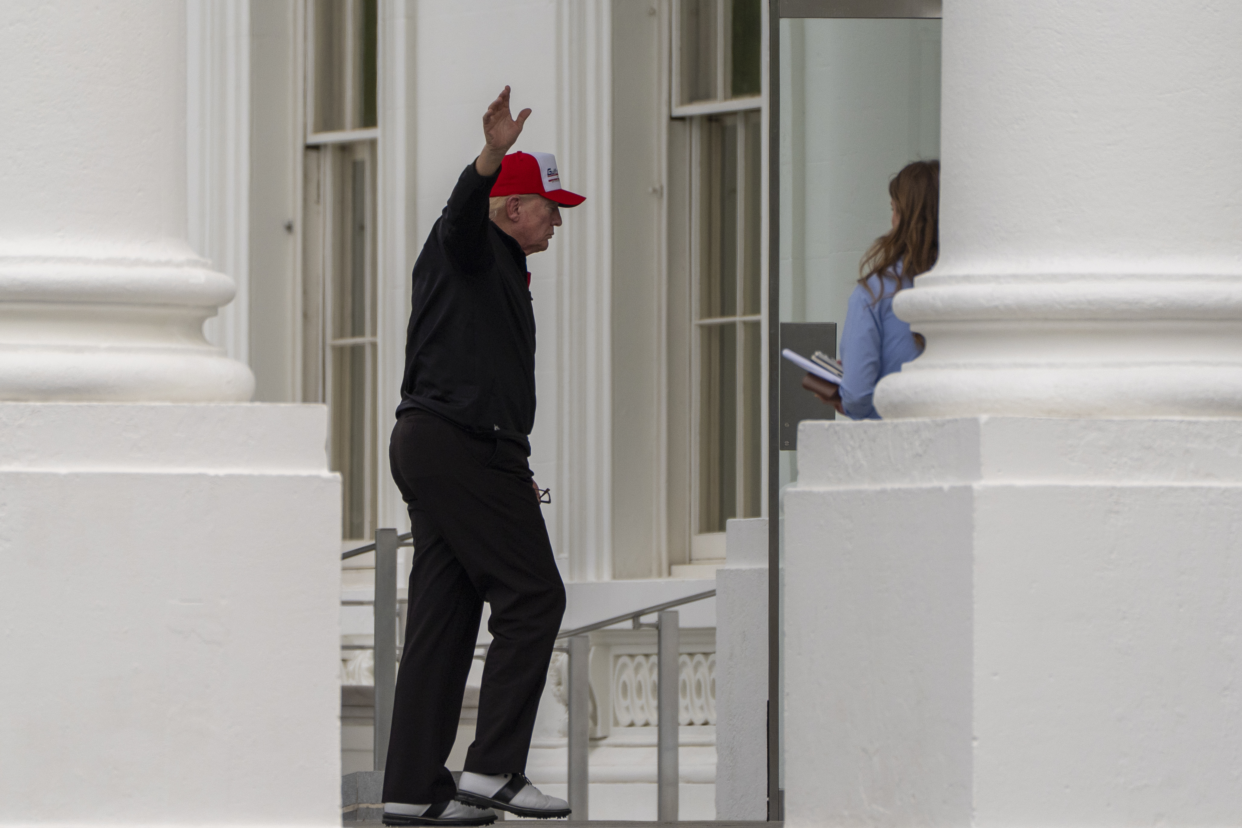 President Donald Trump waves as he returns to the White House, Sunday, April 20, 2025, in Washington. (AP Photo/Alex Brandon)