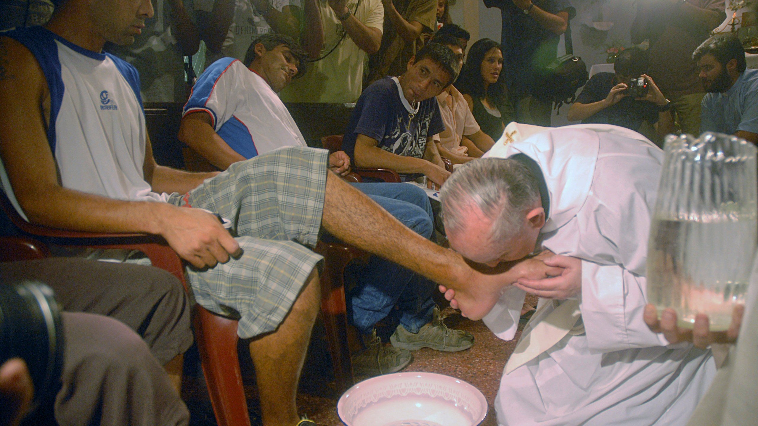 FILE - Argentina's cardinal Jorge Mario Bergoglio, right, kisses the foot of Cristian Marcelo Reynoso during a Mass with youth trying to overcome drug addictions in Buenos Aires, Argentina, Thursday, March 20, 2008. (AP Photo)